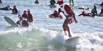 600 surfing Santas ride waves along Florida’s Space Coast